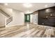 View of the living space featuring luxury vinyl plank flooring, leading to the entryway and staircase at 401 Thomas Point Dr, Fortville, IN 46040
