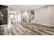 Open concept living space featuring luxury vinyl plank floors with views of the kitchen and staircase at 401 Thomas Point Dr, Fortville, IN 46040
