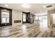 Spacious living area featuring a fireplace, modern floors, natural light, and an open kitchen at 401 Thomas Point Dr, Fortville, IN 46040