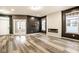 Open living space with luxury vinyl plank flooring, decorative wall accents, and natural lighting at 401 Thomas Point Dr, Fortville, IN 46040