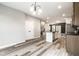 An open layout of the kitchen and living spaces, showing luxury vinyl plank flooring throughout at 401 Thomas Point Dr, Fortville, IN 46040