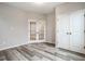 Room with luxury vinyl plank flooring, double doors, and a closet at 401 Thomas Point Dr, Fortville, IN 46040
