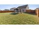 Backyard view showcasing a well-maintained lawn, a gazebo, and a wooden fence at 4213 Katie Ln, Indianapolis, IN 46239