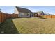 Backyard view showcasing a well-maintained lawn, a gazebo, and a wooden fence at 4213 Katie Ln, Indianapolis, IN 46239