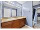 Bathroom featuring double sinks, light fixtures, and a shower/tub with curtain at 4213 Katie Ln, Indianapolis, IN 46239