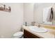Half bathroom features a white oval sink, towel rack, and a decorative Amish countryside print on the wall at 4213 Katie Ln, Indianapolis, IN 46239