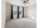 Bright bedroom features plush carpet, a ceiling fan, two large windows, and neutral paint creating a serene space at 4213 Katie Ln, Indianapolis, IN 46239