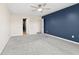 Spacious bedroom featuring a ceiling fan, neutral walls and carpet, and an adjacent walk-in closet at 4213 Katie Ln, Indianapolis, IN 46239