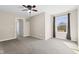 Spacious bedroom with neutral walls, plush gray carpet, a ceiling fan, and a window with ample natural light at 4213 Katie Ln, Indianapolis, IN 46239