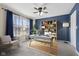 Home office with natural lighting, ceiling fan, and a blue accent wall with a built in bookshelf at 4213 Katie Ln, Indianapolis, IN 46239