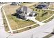 Aerial view of a well maintained home featuring professional landscaping, a driveway, and sidewalks at 4255 Kettering Dr, Zionsville, IN 46077