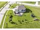 Aerial view showcases home with expansive yard featuring a patio, outdoor kitchen, and beautiful landscaping at 4255 Kettering Dr, Zionsville, IN 46077