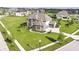 Aerial view of home with pristine lawn, landscaping, and a three-car garage situated in a Gathering-friendly neighborhood at 4255 Kettering Dr, Zionsville, IN 46077