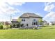 Backyard featuring an outdoor kitchen, comfortable seating area, and a spacious lawn perfect for outdoor activities at 4255 Kettering Dr, Zionsville, IN 46077