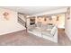 Spacious finished basement with comfortable seating, modern artwork and staircase at 4255 Kettering Dr, Zionsville, IN 46077