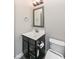 Bathroom featuring a modern vanity, sink, framed mirror, and toilet in a neutral color palette at 4255 Kettering Dr, Zionsville, IN 46077