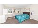 This serene bedroom features two windows, carpeted flooring, and a luxurious tufted headboard for a relaxing retreat at 4255 Kettering Dr, Zionsville, IN 46077