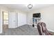 Bright bedroom with a closet, a large window, carpet flooring and TV on a bookshelf at 4255 Kettering Dr, Zionsville, IN 46077