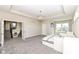 A spacious bedroom with a tray ceiling, a chandelier, and a view of the staircase is a beautiful and comfortable space at 4255 Kettering Dr, Zionsville, IN 46077