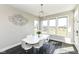 Bright dining area featuring contemporary chandelier, ample natural light, and access to backyard views at 4255 Kettering Dr, Zionsville, IN 46077