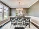Traditional dining room with wainscoting, chandelier, and large windows that provide ample natural light at 4255 Kettering Dr, Zionsville, IN 46077