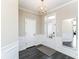 Elegant entryway with modern light fixture, decorative mirror, and paneled walls at 4255 Kettering Dr, Zionsville, IN 46077