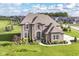 Gorgeous brick home showcases manicured lawns, beautiful landscaping, and elegant architectural design in a Gathering-friendly neighborhood at 4255 Kettering Dr, Zionsville, IN 46077
