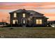 Beautiful brick home with a manicured lawn and inviting front entrance at sunset at 4255 Kettering Dr, Zionsville, IN 46077