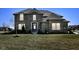 Inviting two-story home with a well-maintained lawn and traditional brick facade at 4255 Kettering Dr, Zionsville, IN 46077