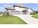 Spacious three-car attached garage with driveway, lush lawn and professional landscaping at 4255 Kettering Dr, Zionsville, IN 46077