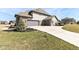 Attached three-car garage with a concrete driveway and manicured landscaping at 4255 Kettering Dr, Zionsville, IN 46077
