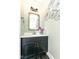 Stylish half bathroom featuring a black vanity, brushed gold faucet, and modern lighting at 4255 Kettering Dr, Zionsville, IN 46077
