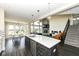 Modern kitchen features an island, stainless steel appliances, and open floor plan to the living room at 4255 Kettering Dr, Zionsville, IN 46077