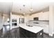 Modern kitchen features a large island, stainless steel appliances, and sleek white cabinets at 4255 Kettering Dr, Zionsville, IN 46077