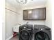 This laundry room boasts modern washer and dryer units, upper cabinets, and a utility sink for all laundry needs at 4255 Kettering Dr, Zionsville, IN 46077