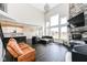 Open-concept living room with fireplace, large windows, and seamlessly connected to the kitchen and dining area at 4255 Kettering Dr, Zionsville, IN 46077