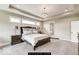 Main bedroom features tray ceiling, neutral walls and carpet, generous natural light, and en suite bathroom at 4255 Kettering Dr, Zionsville, IN 46077