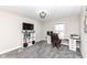 This home office features a built-in desk, shelving, a comfortable chair, and a large window for natural light at 4255 Kettering Dr, Zionsville, IN 46077
