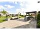 Outdoor patio features stone pavers, outdoor seating, dining area with grill, and tasteful landscaping at 4255 Kettering Dr, Zionsville, IN 46077