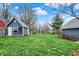 Expansive backyard with lush green grass, a garden shed, and mature trees offering shade and privacy at 450 W Ash St, Zionsville, IN 46077