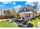 Enjoy outdoor living on the stone patio with cozy seating and mature trees surrounding the property at 450 W Ash St, Zionsville, IN 46077
