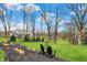 Spacious backyard with patio seating, a garden and mature trees, perfect for outdoor entertaining at 450 W Ash St, Zionsville, IN 46077