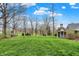 Large backyard with mature trees, a gazebo, and well-maintained lawn offering a tranquil outdoor space at 450 W Ash St, Zionsville, IN 46077