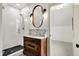Elegant bathroom showcasing a tiled shower, vanity with unique sink, and decorative mirror at 450 W Ash St, Zionsville, IN 46077