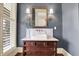 Well-lit powder room featuring vessel sink, unique vanity, and decorative fixtures with a traditional design at 450 W Ash St, Zionsville, IN 46077