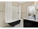 Bathroom featuring a claw foot tub, vanity, patterned tile floor and a large window at 450 W Ash St, Zionsville, IN 46077