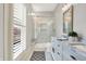 Bright bathroom features double vanity with marble countertop and large glass enclosed shower at 450 W Ash St, Zionsville, IN 46077