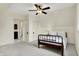 Well-lit bedroom with a decorative vintage bed, neutral walls, and a ceiling fan at 450 W Ash St, Zionsville, IN 46077