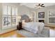 Bedroom with light grey walls, windows with shutters, and ceiling fan at 450 W Ash St, Zionsville, IN 46077
