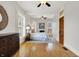 Bedroom with wood floors, ceiling fan, and a decorative dresser to the side at 450 W Ash St, Zionsville, IN 46077